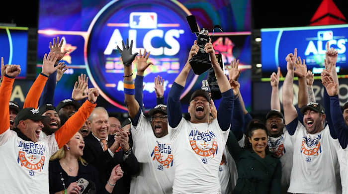 Oct 23, 2022; Bronx, New York, USA; Houston Astros first baseman Yuli Gurriel (10) holds the trophy after defeating the New York Yankees during game four of the ALCS for the 2022 MLB Playoffs at Yankee Stadium.